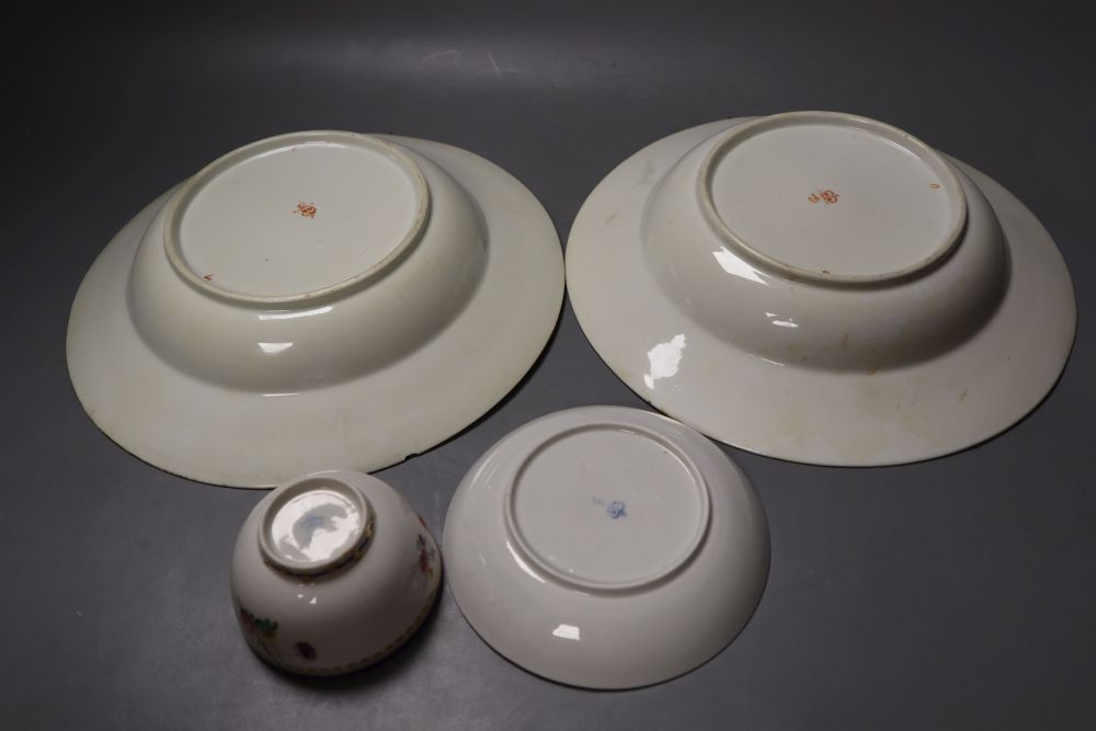 A Chelsea Derby teabowl and saucer painted in the style of Edward Withers with flowers under a blue border and a pair of soup plates